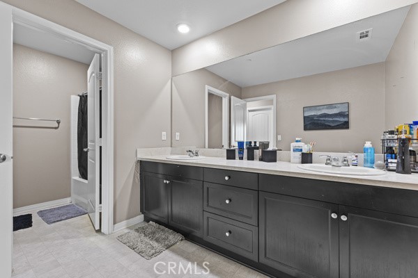 23347 Crystal Way Wildomar, CA 92595 - Photo 17 of 32 a en suite bathroom with a double vanity sink and a mirror