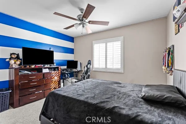 a bedroom with furniture and a flat screen tv