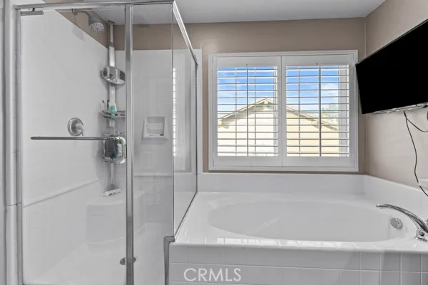 a bathroom with a bathtub and a shower