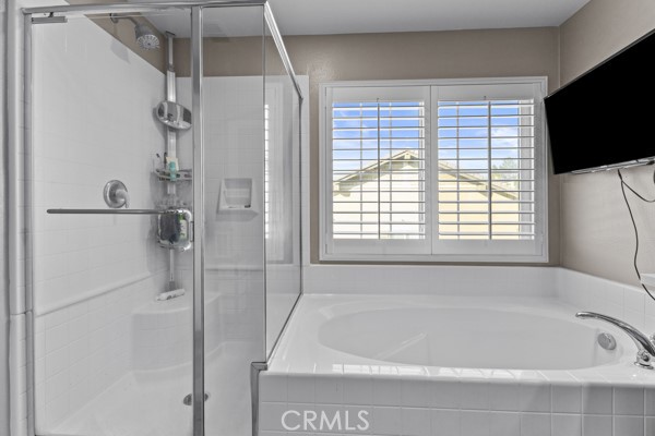 23347 Crystal Way Wildomar, CA 92595 - Photo 24 of 32 a bathroom with a bathtub and a shower