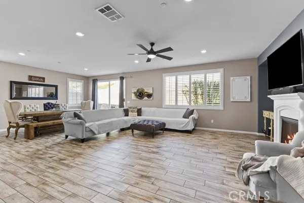 a living room with fireplace furniture and a flat screen tv