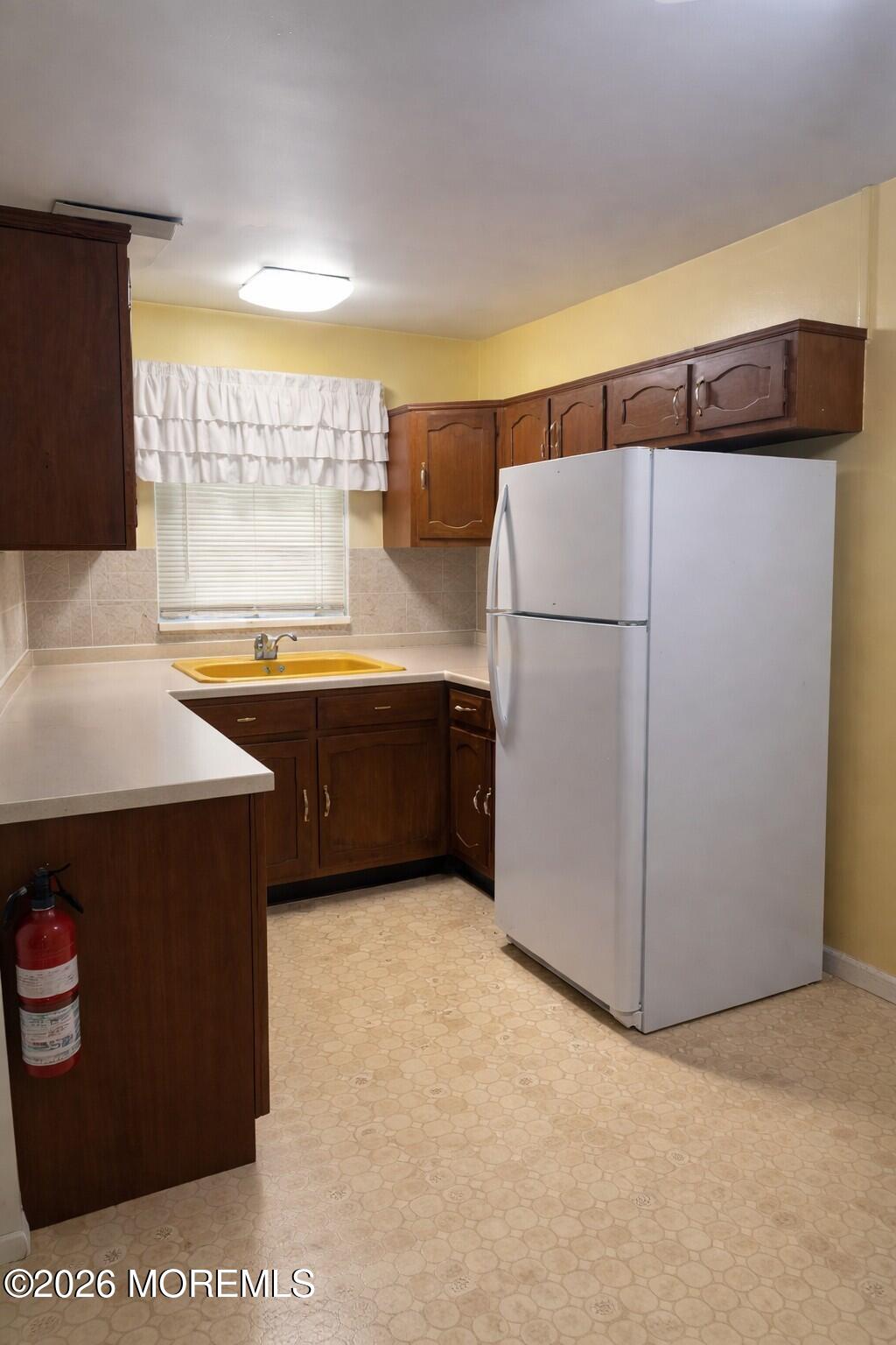 3 Quaker Lane, Unit D Whiting, NJ 08759 - Photo 4 of 9 a kitchen with stainless steel appliances a refrigerator a sink a stove and white cabinets