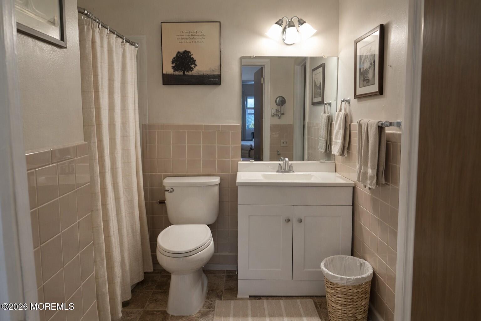 3 Quaker Lane, Unit D Whiting, NJ 08759 - Photo 7 of 9 a bathroom with a toilet sink and mirror