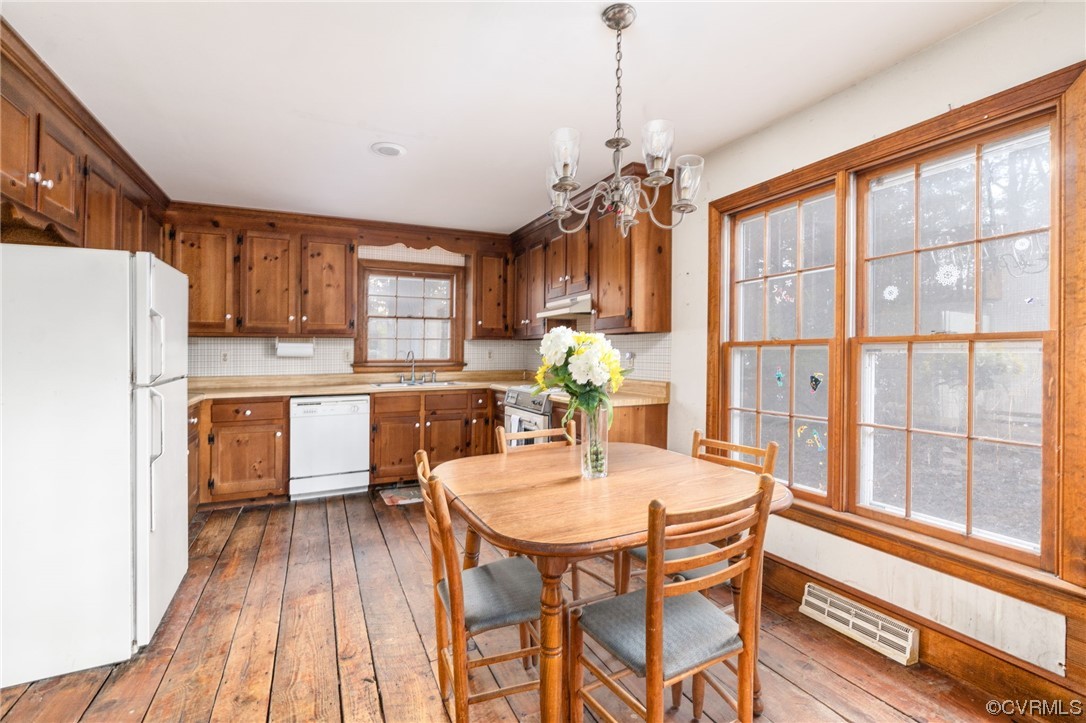 18910 Duval Road Moseley, VA 23120 - Photo 11 of 26 a kitchen with a table chairs refrigerator and microwave