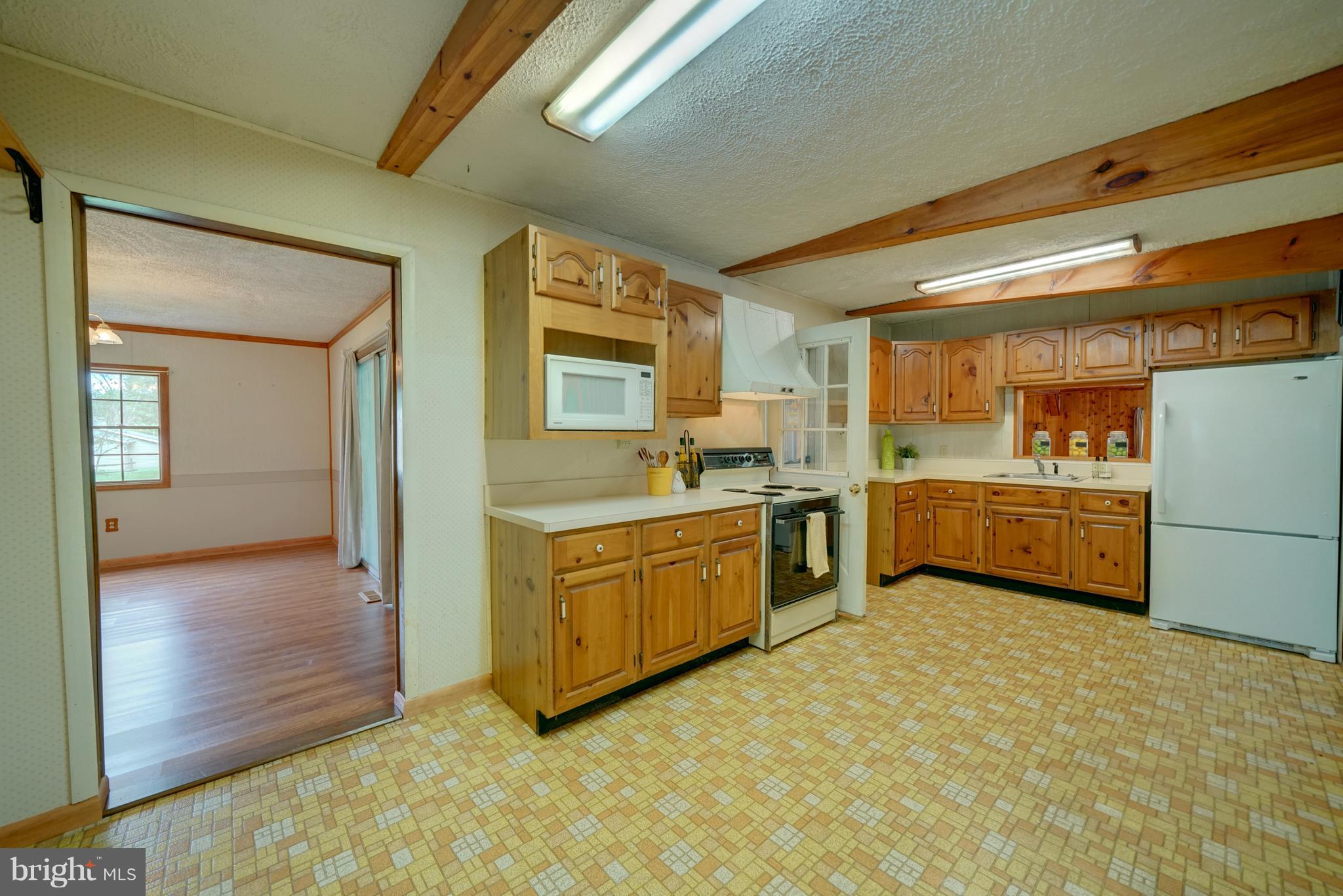 241 Burns Crossing Road Severn, MD 21144 - Photo 14 of 30 a kitchen with a refrigerator sink and cabinets