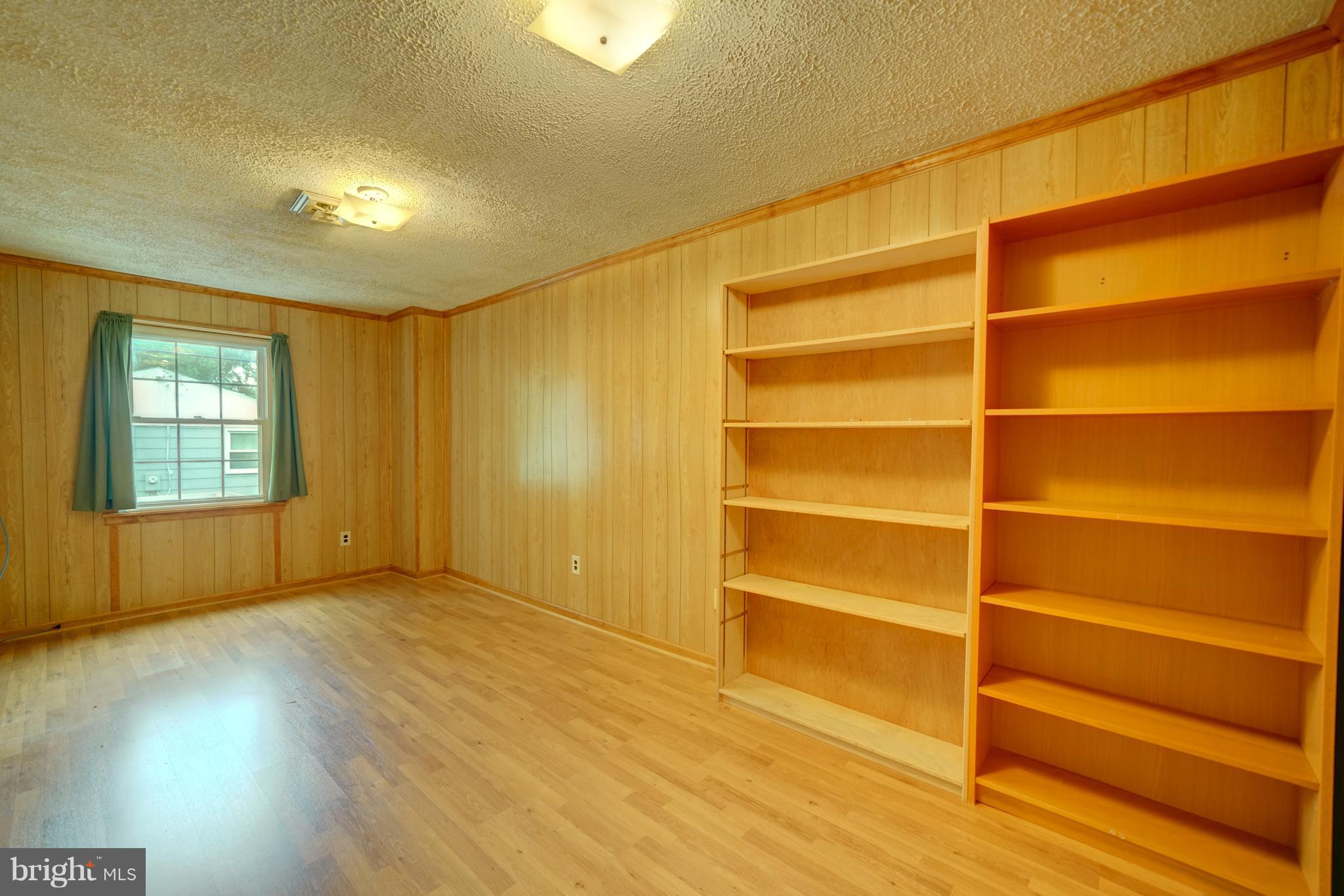 241 Burns Crossing Road Severn, MD 21144 - Photo 22 of 30 a view of an empty room with a window and wooden floor
