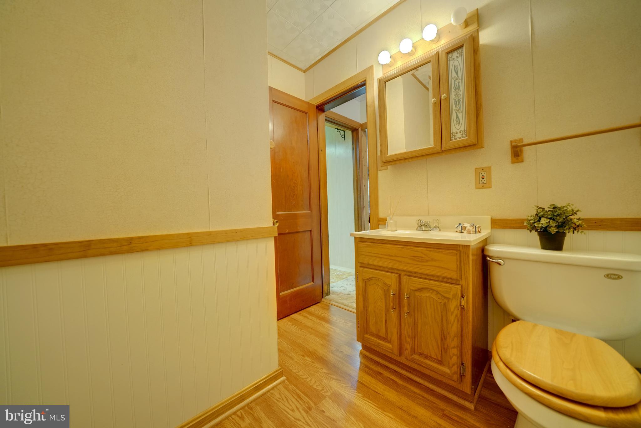 241 Burns Crossing Road Severn, MD 21144 - Photo 26 of 30 a bathroom with a granite countertop sink toilet and shower