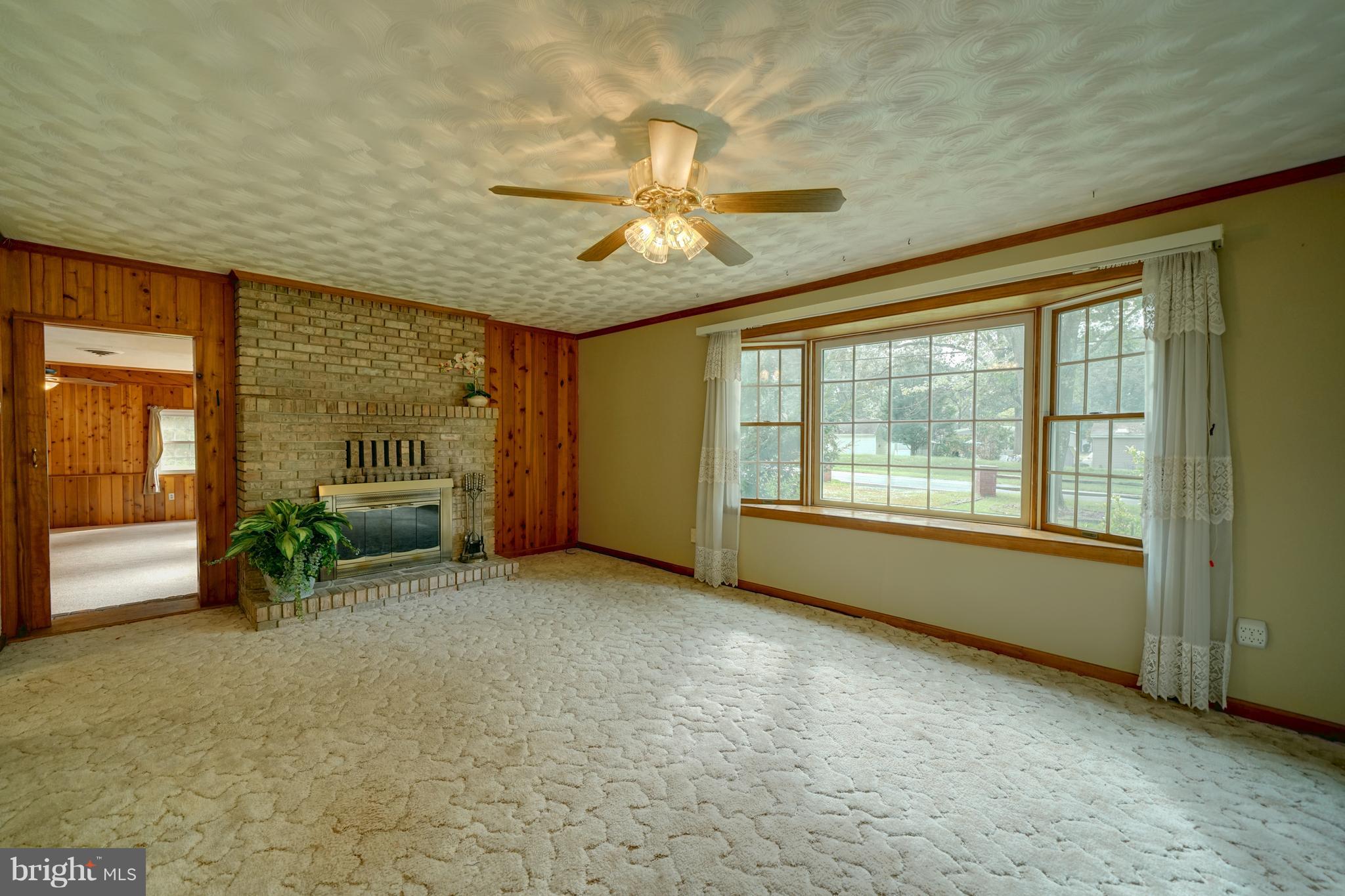 241 Burns Crossing Road Severn, MD 21144 - Photo 10 of 30 a view of an empty room with a fireplace and a window