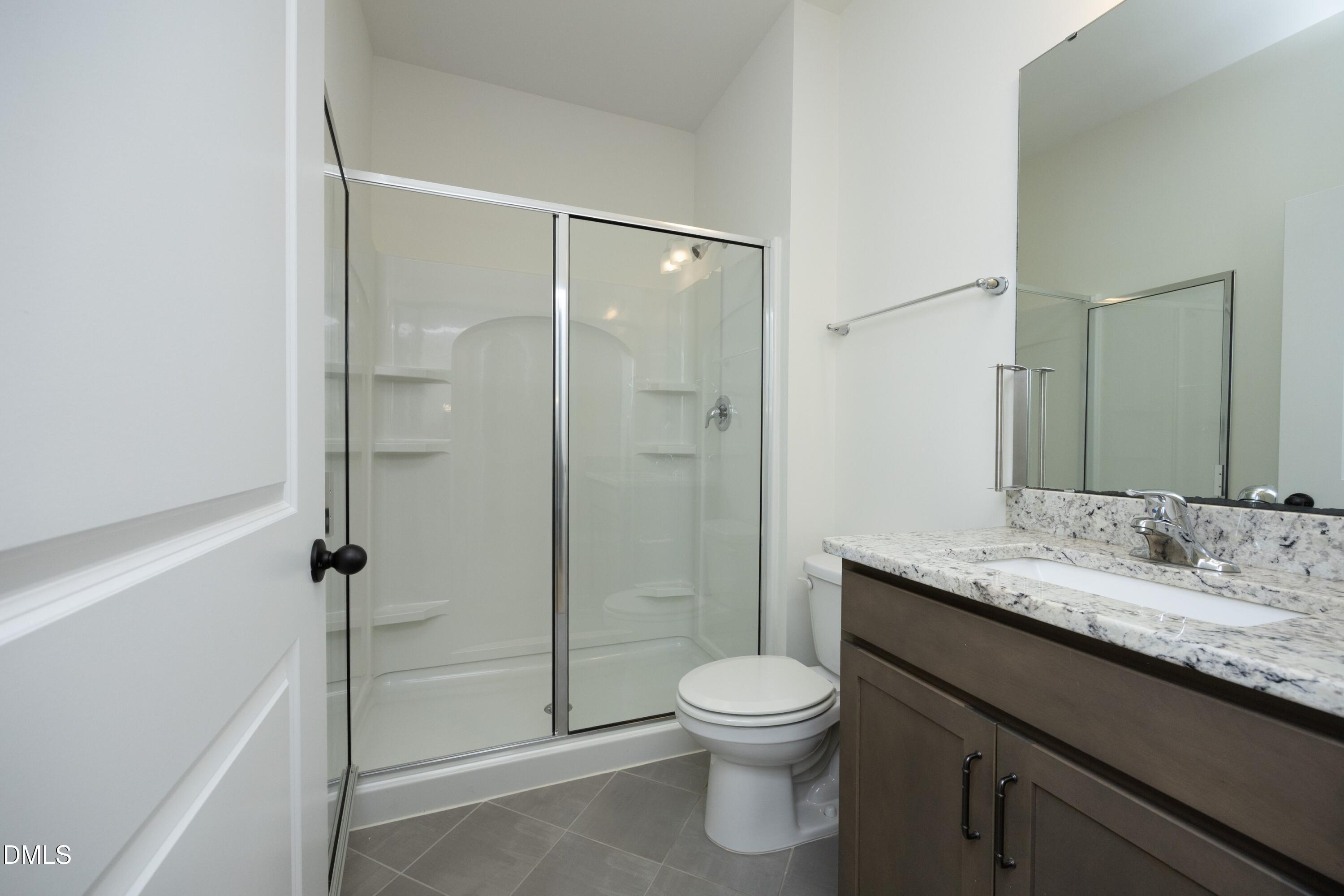 824 Country Downs Road Wake Forest, NC 27587 - Photo 32 of 41 a bathroom with a granite countertop sink toilet and shower