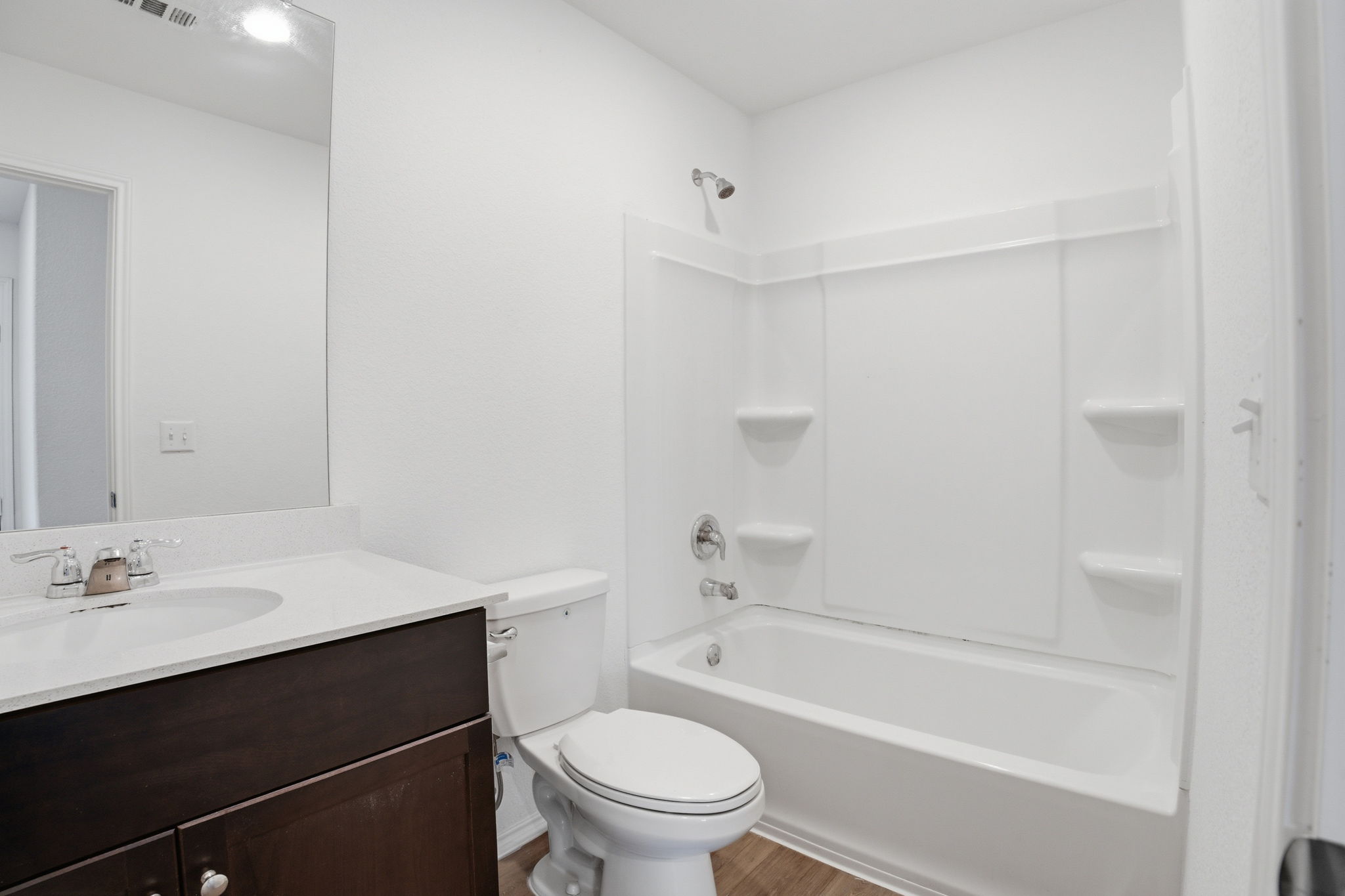 12213 Rising Moon Lane Del Valle, TX 78617 - Photo 11 of 19 a bathroom with a sink a toilet and a bathtub
