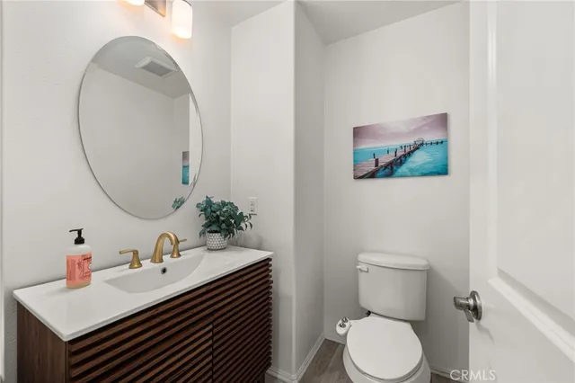 a bathroom with a sink mirror and toilet