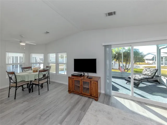 a kitchen with stainless steel appliances granite countertop a refrigerator a stove and a sink