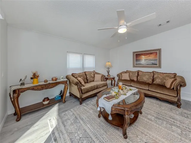 a kitchen with granite countertop a stove sink and cabinets