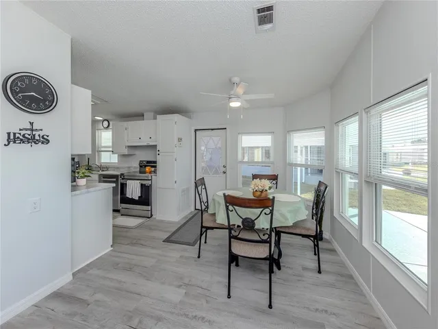 a kitchen with stainless steel appliances granite countertop a stove top oven a sink dishwasher and white cabinets