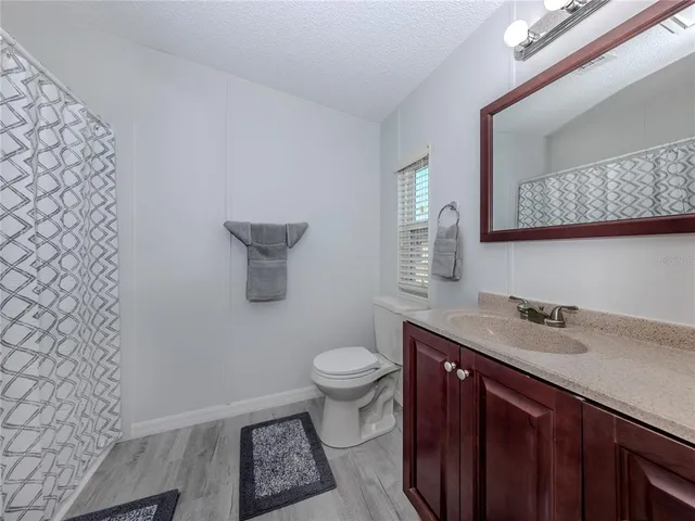 a view of a sign in a yard with potted plants