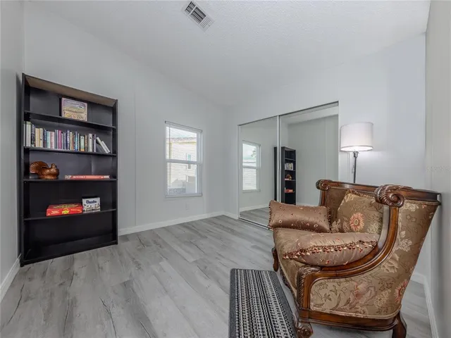 a view of a swimming pool with a lawn chairs under an umbrella
