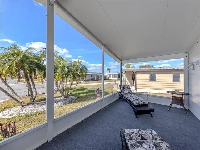 a living room with furniture a rug and a book shelf