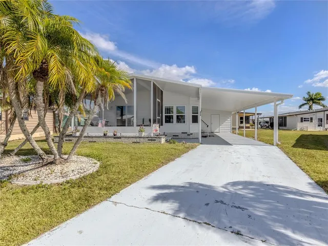 a view of a house with swimming pool and sitting area