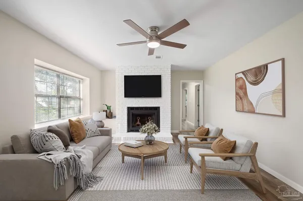 a living room with furniture a fireplace and a window