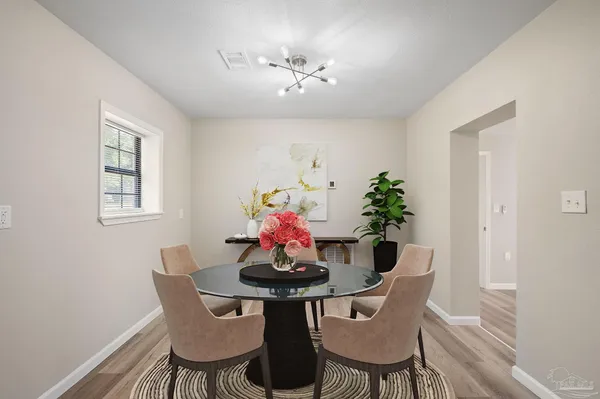 a dining room with furniture and window