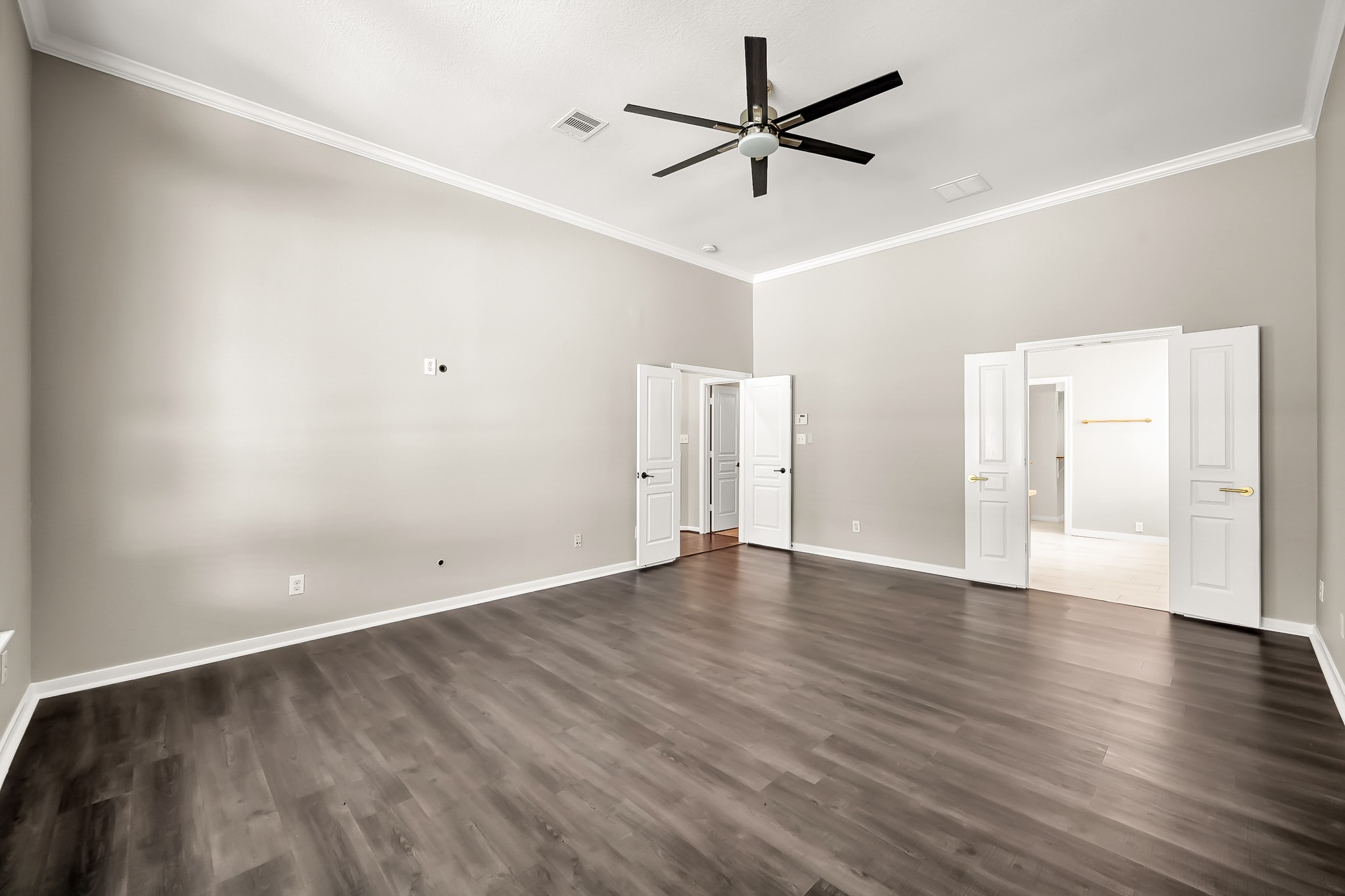 2425 West Bramlet Drive Conroe, TX 77304 - Photo 11 of 31 an empty room with wooden floor and windows