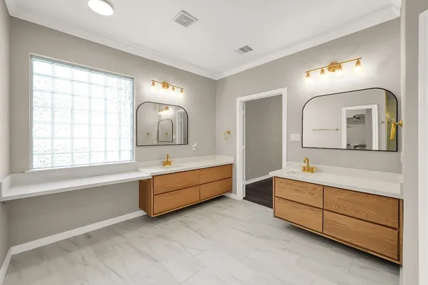 a bathroom with a double vanity sink tub and mirror