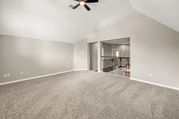 a view of empty room with a kitchen