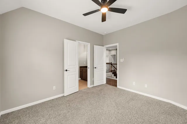 an empty room with a empty space and a ceiling fan