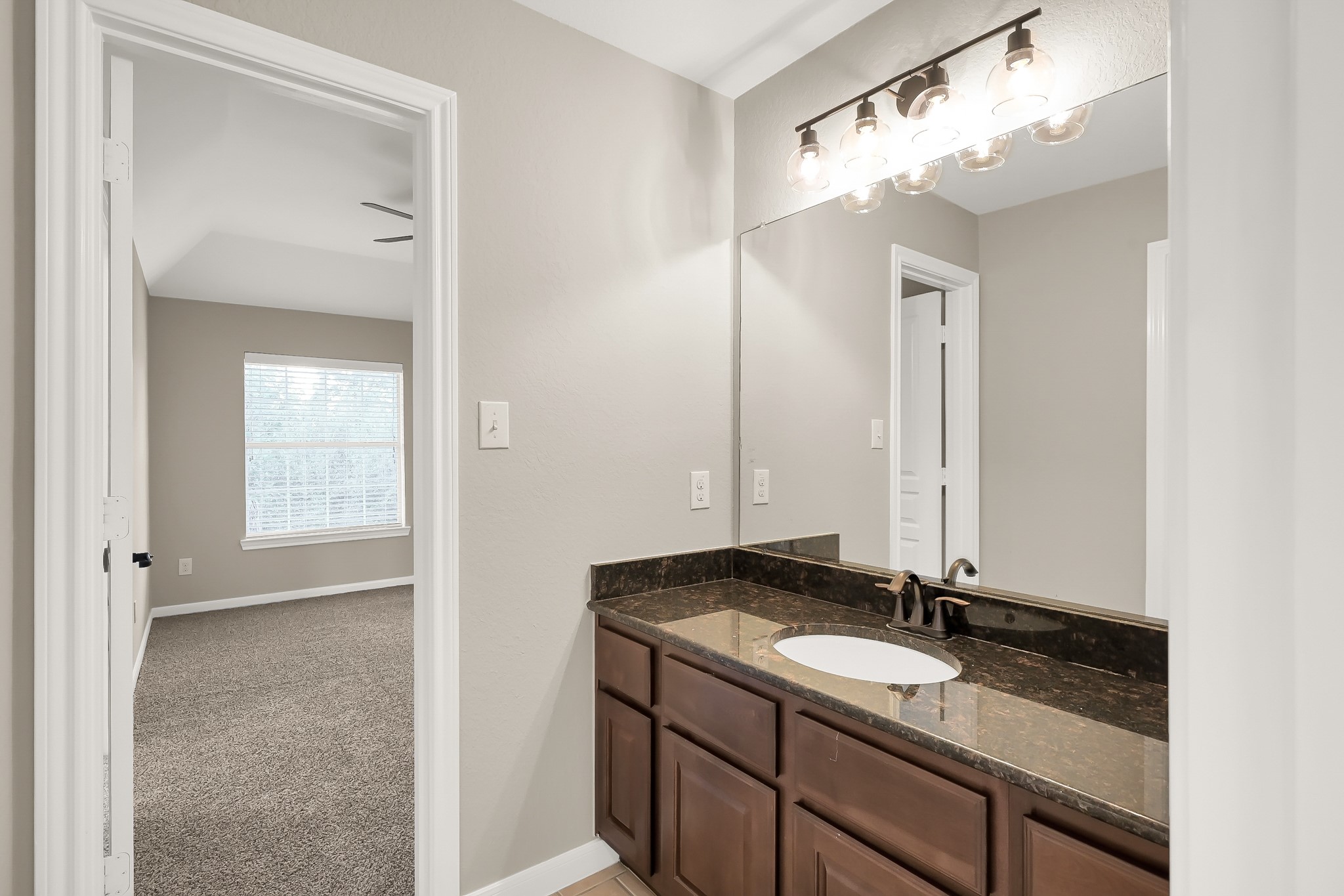 2425 West Bramlet Drive Conroe, TX 77304 - Photo 18 of 31 a bathroom with a sink and a mirror