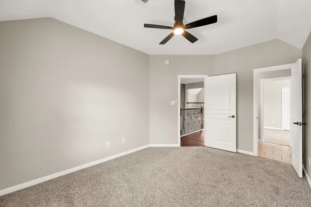 an empty room with closet and windows