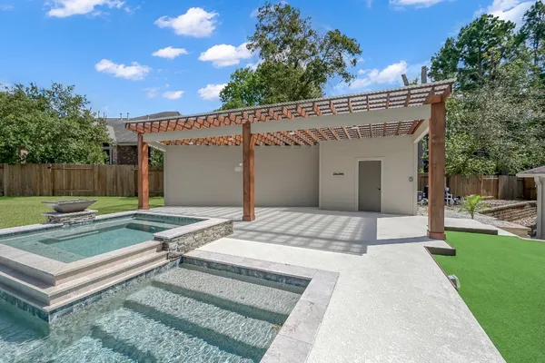 a view of a house with backyard and sitting area