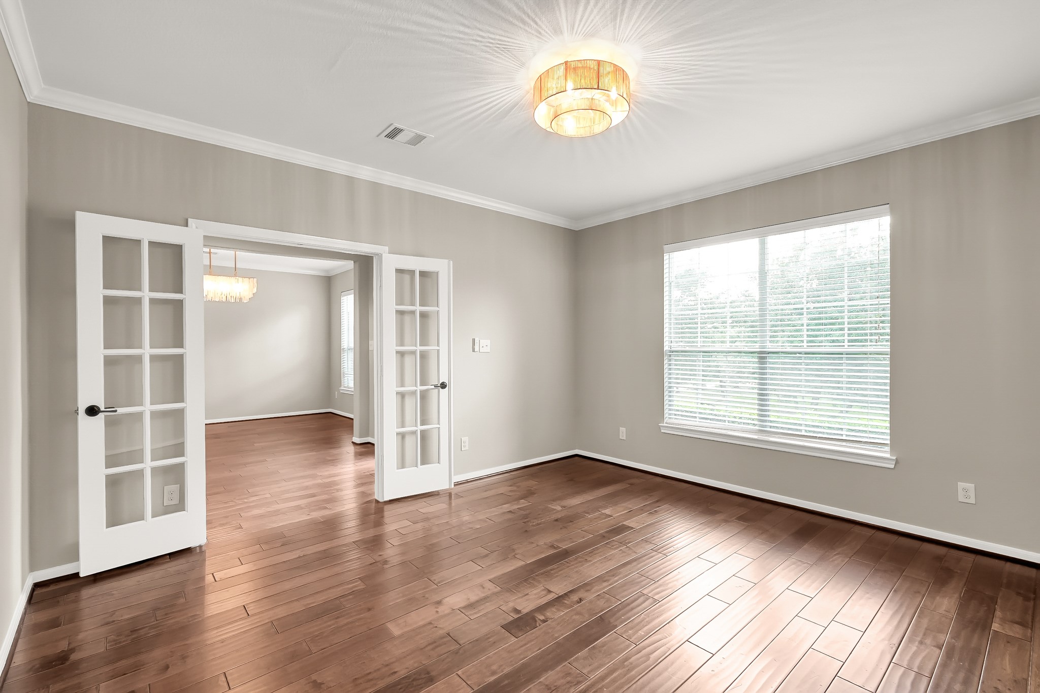 2425 West Bramlet Drive Conroe, TX 77304 - Photo 4 of 31 an empty room with wooden floor and window