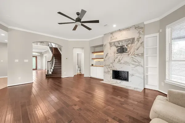 a living room with fireplace furniture and a wooden floor