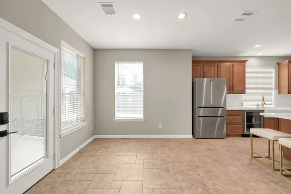 a kitchen with a refrigerator and a stove top oven