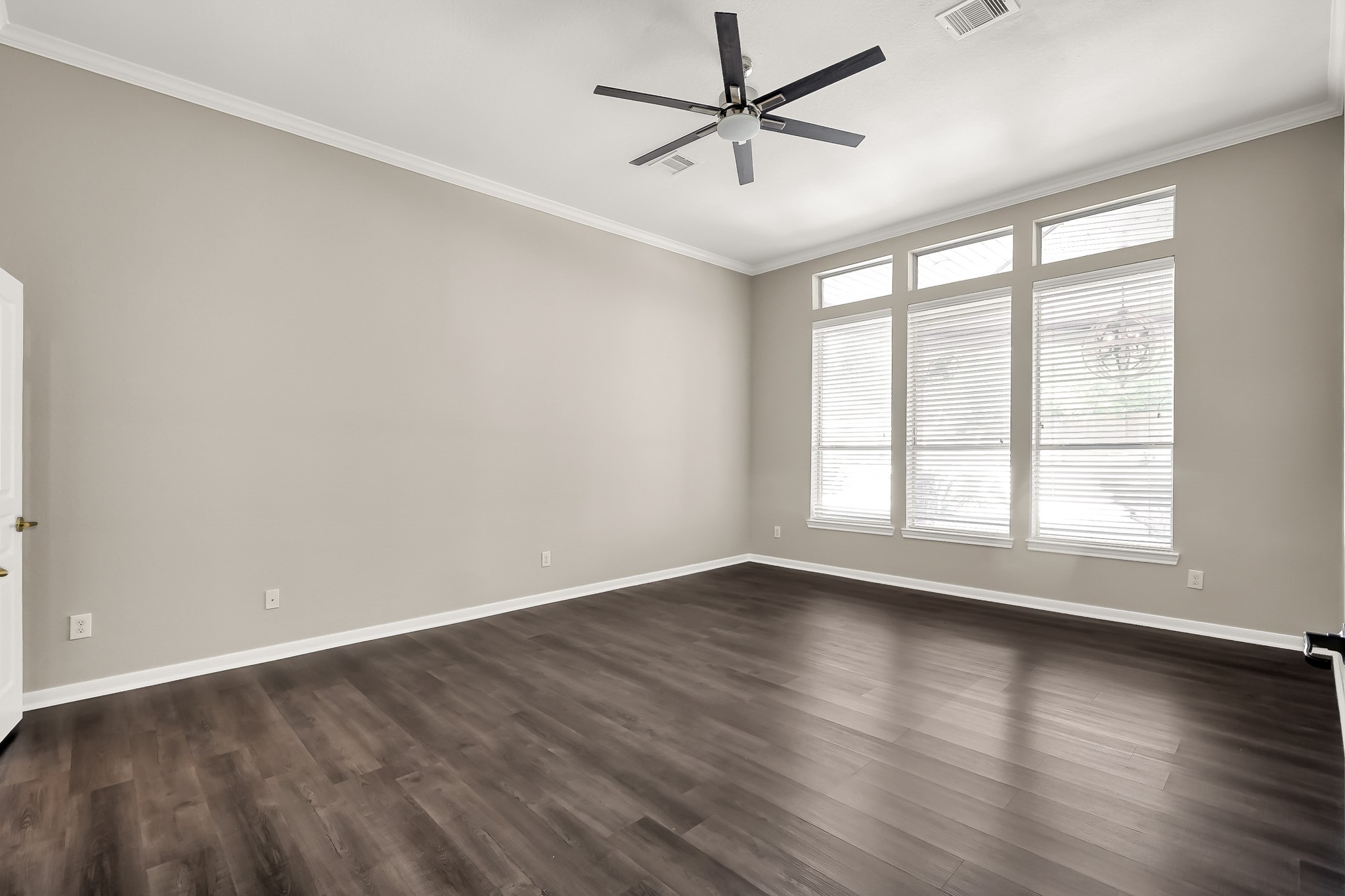 2425 West Bramlet Drive Conroe, TX 77304 - Photo 10 of 31 an empty room with wooden floor and windows