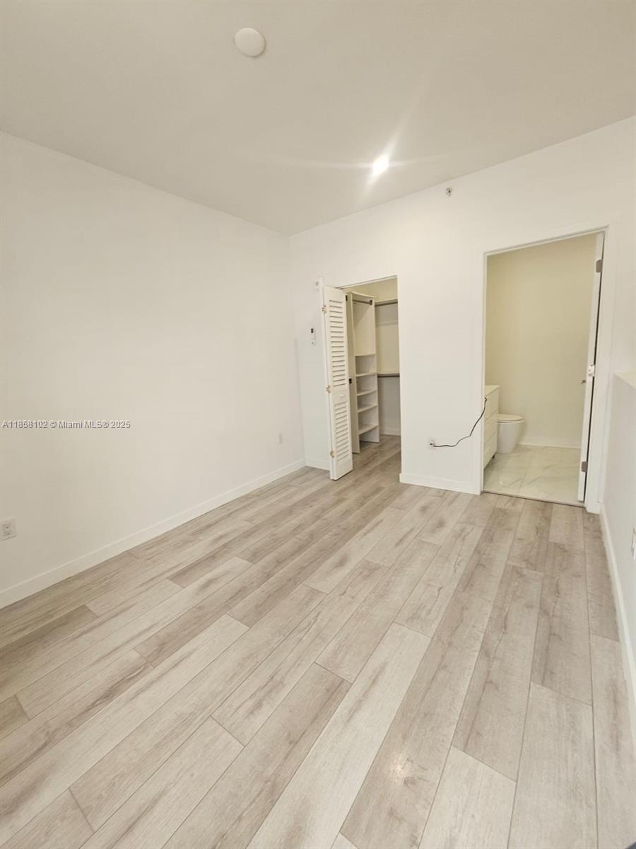 1610 Euclid Avenue, Unit A107 Miami Beach, FL 33139 - Photo 11 of 14 a view of empty room with wooden floor