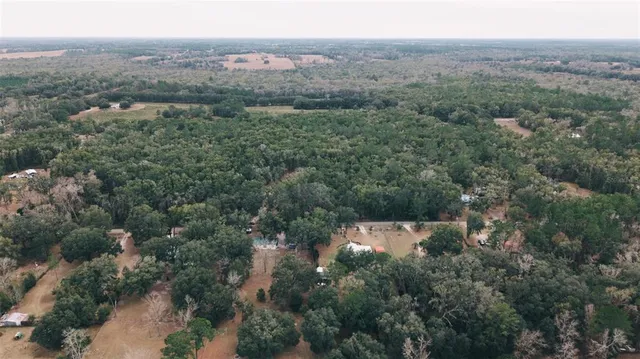 an aerial view of house with yard and mountain view