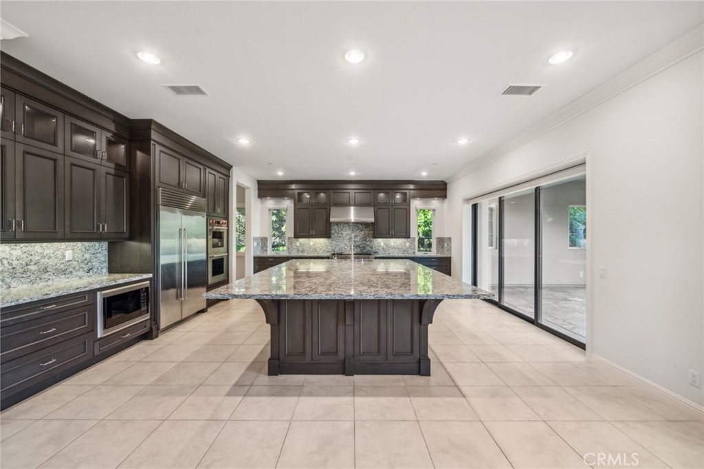 111 Whiteplume Irvine, CA 92618 - Photo 11 of 66 a large kitchen with stainless steel appliances granite countertop a large counter top and oven