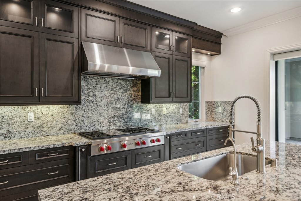 111 Whiteplume Irvine, CA 92618 - Photo 13 of 66 a kitchen with stainless steel appliances granite countertop a sink stove and cabinets