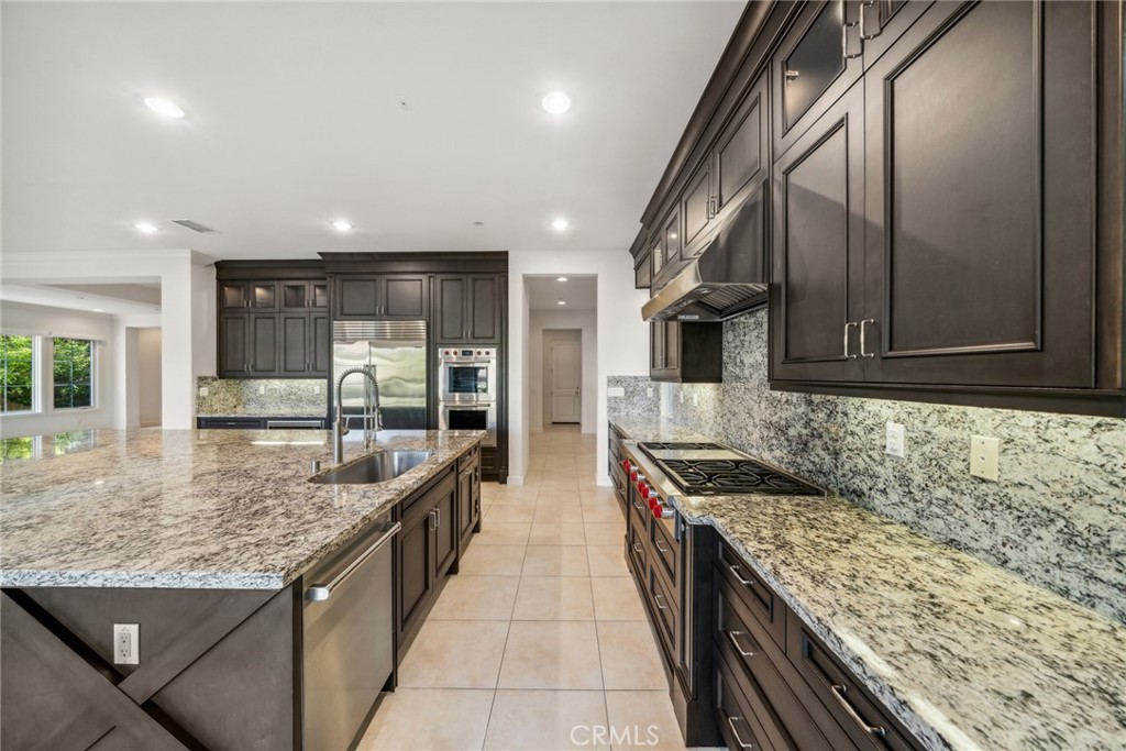 111 Whiteplume Irvine, CA 92618 - Photo 14 of 66 a kitchen with stainless steel appliances granite countertop a sink and a refrigerator