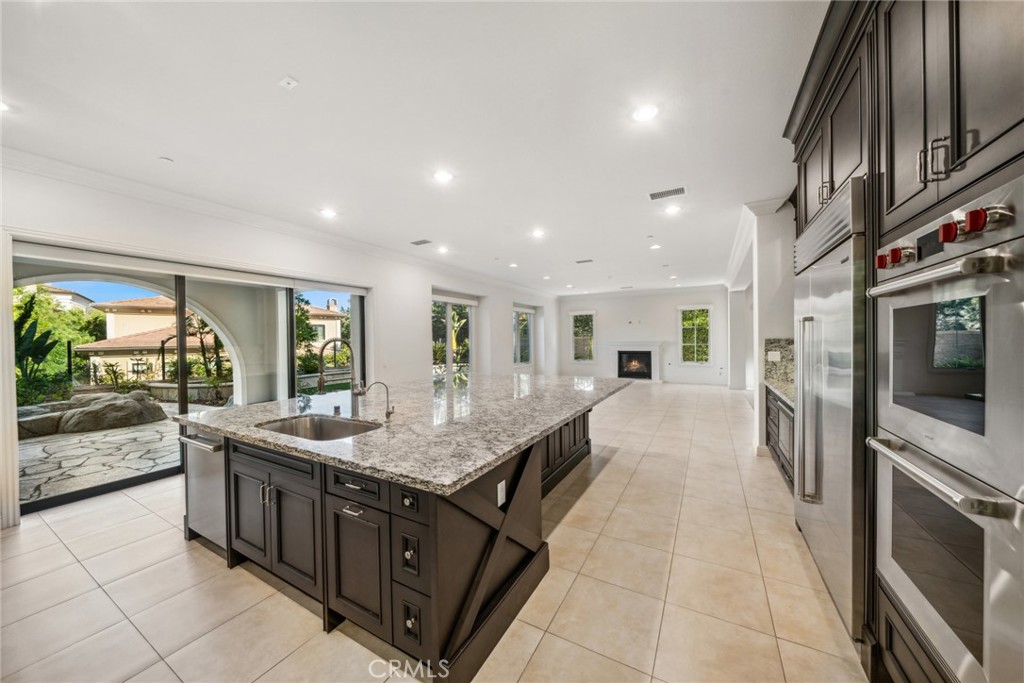 111 Whiteplume Irvine, CA 92618 - Photo 16 of 66 a large kitchen with kitchen island granite countertop a large counter top and stainless steel appliances