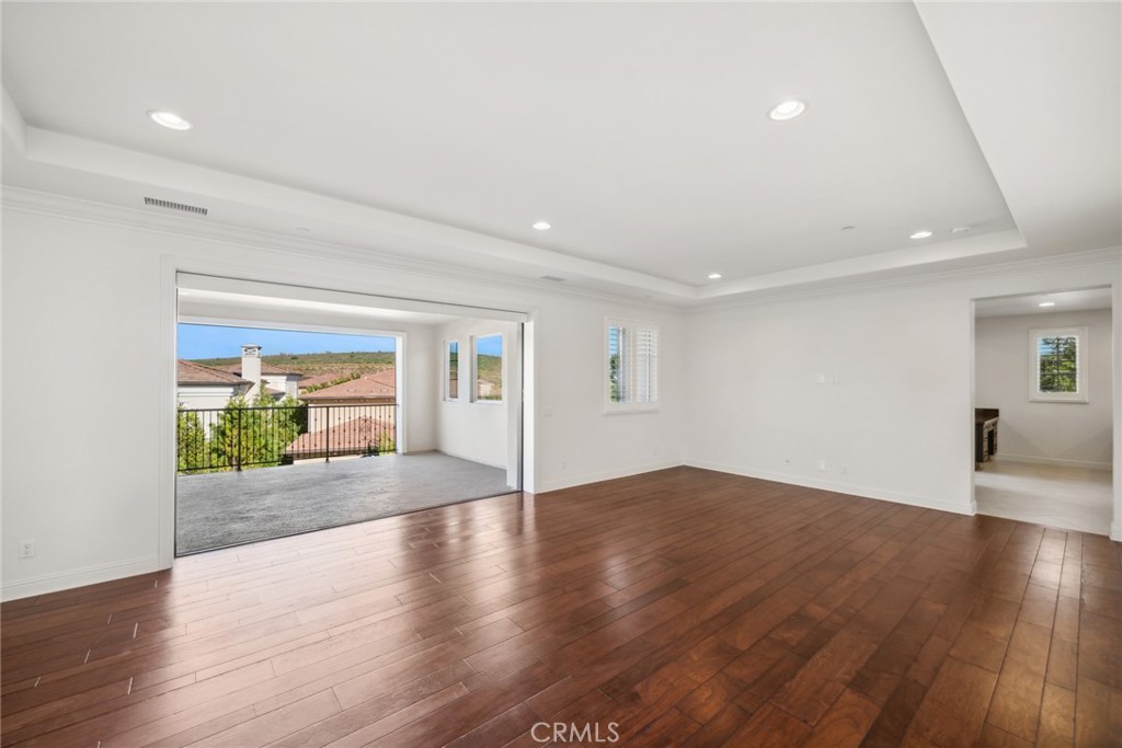 111 Whiteplume Irvine, CA 92618 - Photo 32 of 66 a view of an empty room with wooden floor and a window