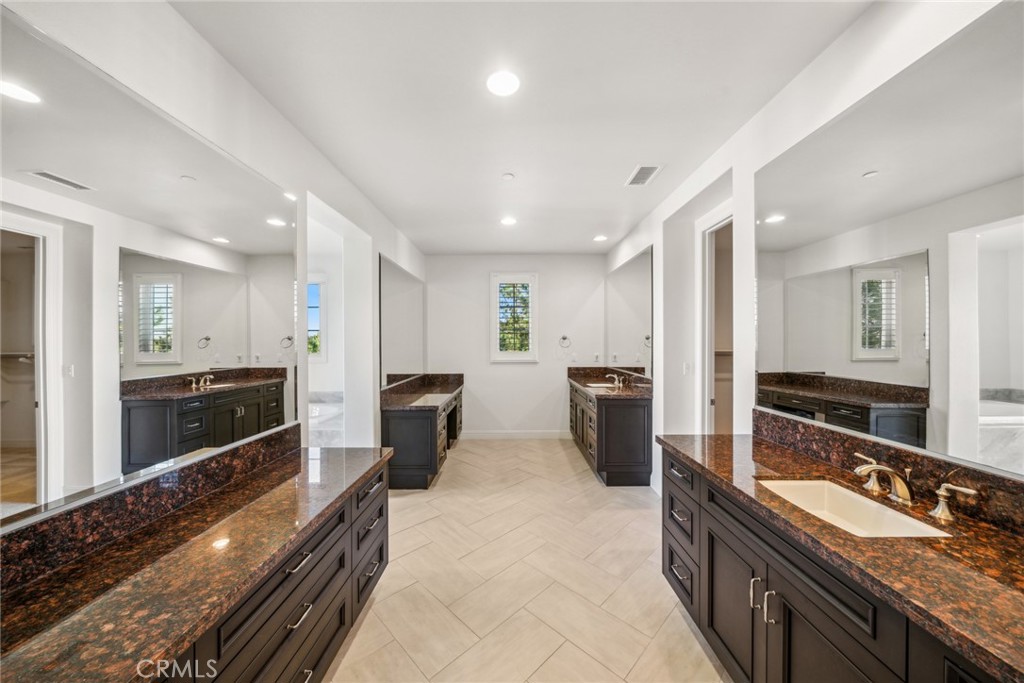 111 Whiteplume Irvine, CA 92618 - Photo 35 of 66 a large kitchen with a large counter top stainless steel appliances and cabinets