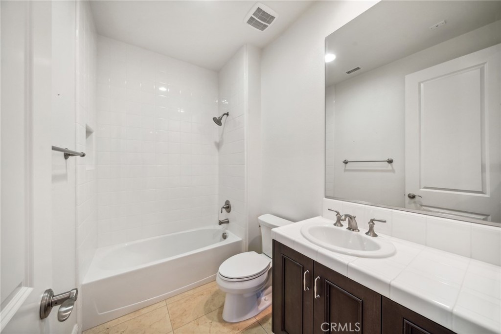 111 Whiteplume Irvine, CA 92618 - Photo 43 of 66 a bathroom with a granite countertop sink toilet and shower