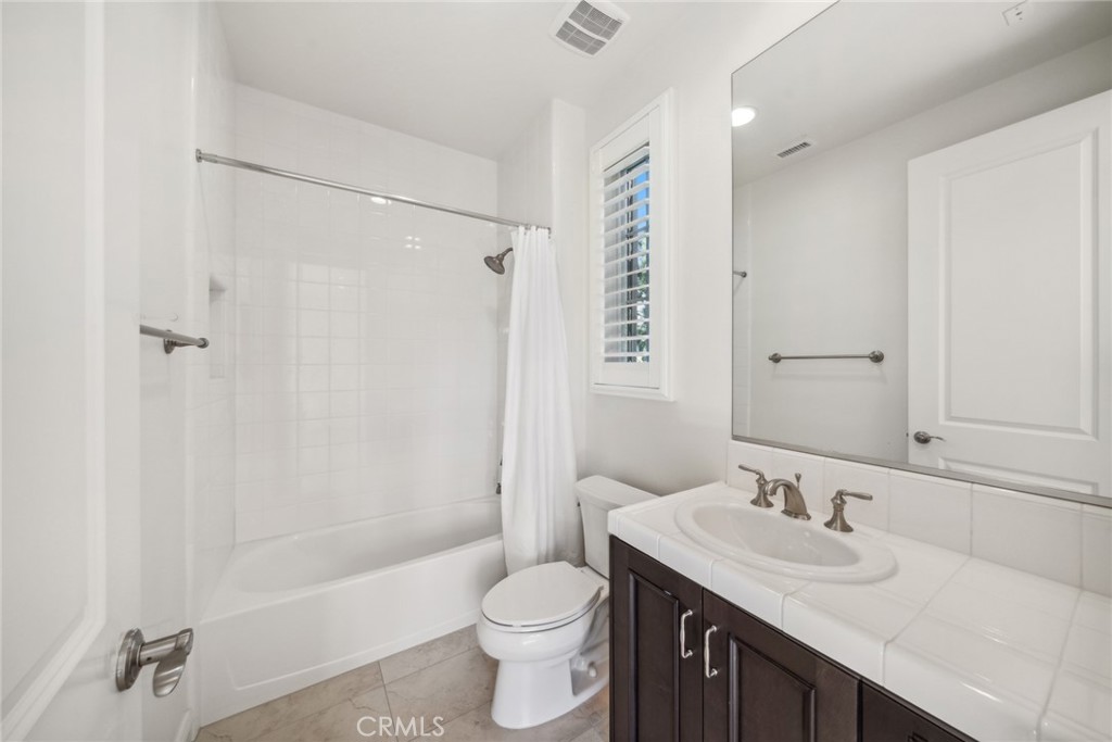 111 Whiteplume Irvine, CA 92618 - Photo 45 of 66 a bathroom with a granite countertop sink toilet and shower