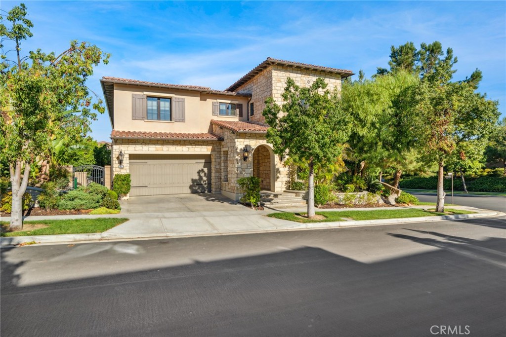 111 Whiteplume Irvine, CA 92618 - Photo 48 of 66 a front view of a house with a yard and garage