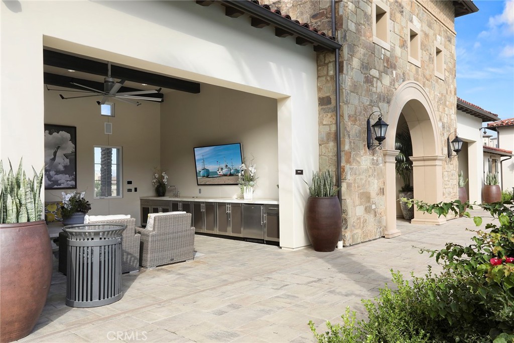 111 Whiteplume Irvine, CA 92618 - Photo 57 of 66 a view of living room kitchen with stainless steel appliances kitchen island granite countertop furniture and a fireplace