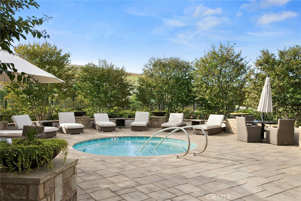 111 Whiteplume Irvine, CA 92618 - Photo 63 of 66 a view of a patio with dining table and chairs with wooden fence