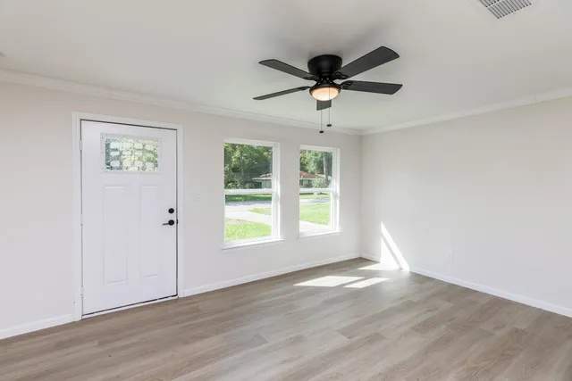 wooden floor in an empty room with a window