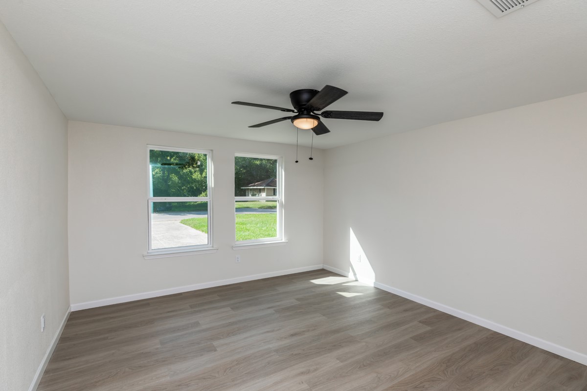 5260 Landry Lane Beaumont, TX 77708 - Photo 14 of 25 an empty room with wooden floor and windows